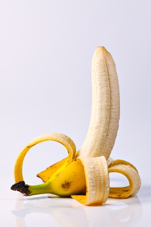Peeled banana on white backgroundの写真素材
