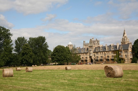 Oxford, England, July 2009 - Oxford University, Christ Church College viewed behind hay cut in meadowのeditorial素材