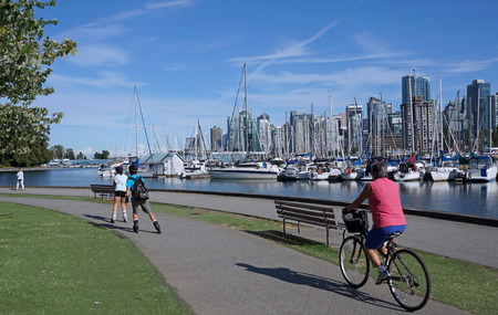VANCOUVER - JULY 2015: Stanley Park is Vancouver's most visited attraction, and the seawall path for cyclists and joggers gives great views of the harborのeditorial素材