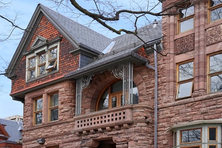 old stone college building with gable and balconyのeditorial素材