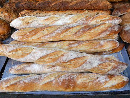 Tray of freshly baked baguettes at bakeryの写真素材