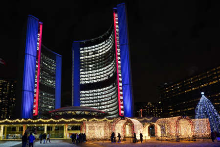 Toronto, Canada - November 30, 2021:  Toronto City Hall square is lit up with bright lights in...