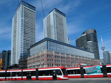 Toronto, Canada - September 3, 2021:  A modern articulating streetcars, with high rise apartment buildings in the backgroundのeditorial素材