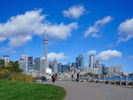 Toronto, Canada - October 27, 2021:  Runners and cyclists enjoy a warm fall day on the recreational trail beside Lake Ontario near downtown Toronto.のeditorial素材