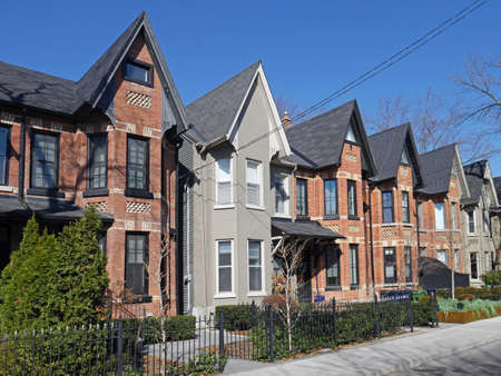 Street with row of narrow brick houses with gables
