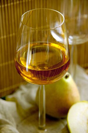 A glass with some drink and pears. Shallow DOF.