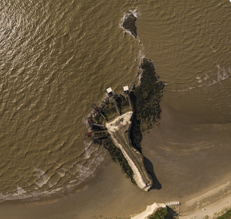 Traditional fisherman wooden hut at the bottom of the limestone cliff in the estuary of Gironde, Meschers-sur-Gironde, Franceの写真素材