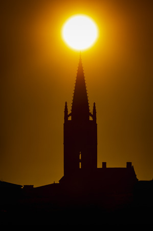 Beautiful sunrise on the steeple of the church and village of Saint Emilion, Religion, Gironde, France,の写真素材