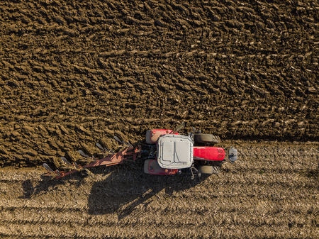 Aerial view, Tractor plowing fields, preparing land for sowing, Gironde, Franceの写真素材