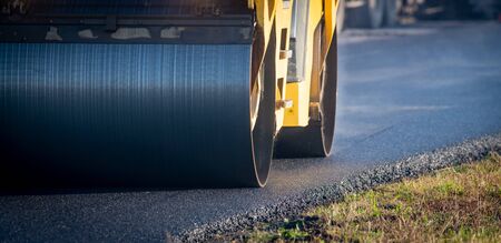 A roller compacting asphalt on a roadの写真素材
