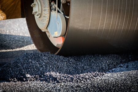 A roller compacting asphalt on a roadの写真素材