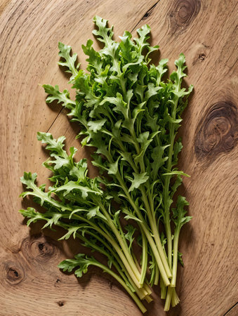 Fresh arugula leaves on wooden background. Top view.の素材