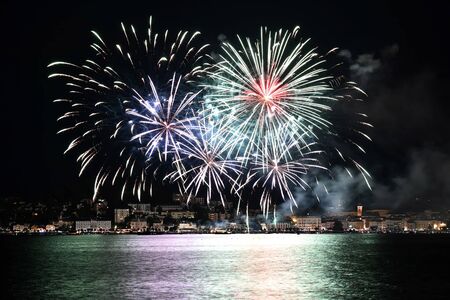 The festival of lights in Gmunden thrills thousands of visitors every year. Fireworks let the city and Lake Traunsee shine in bright colors.の写真素材