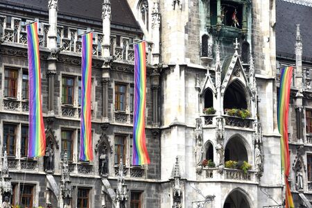 Rainbow-flags at Munich town hall while csd-parade - The CSD parade is a political demonstration and a colorful parade that takes place annually in Munich. It is committed to the equality of gays and lesbians.の写真素材