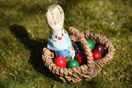 Corona crisis - The chocolate Easter bunny is wearing a protective mask for the nose and mouth this...