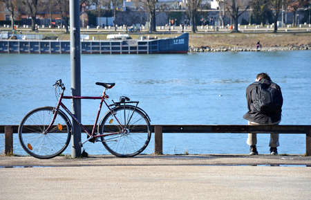 A cyclist takes a break in Linz on the Danubeのeditorial素材