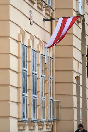 The Austrian flag is waving on a building in Vienna.のeditorial素材