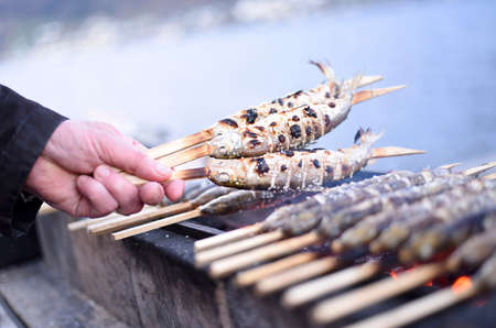 Stick fish - a grilled fish specialty in the Salzkammergut, Austria, Europeの写真素材