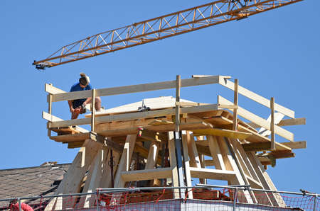 A carpenter on a roof construction site in the Salzkammergut