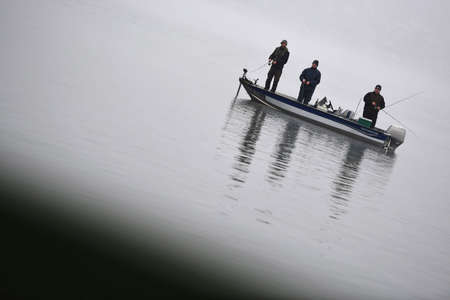Fishing boat on the Traunsee in the morning mist in autumn, Austria, Europeのeditorial素材