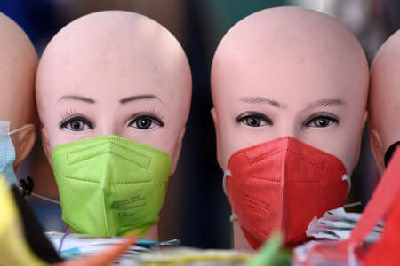 Colored FFP2 masks on dolls heads in Vienna, Austria, Europeの写真素材