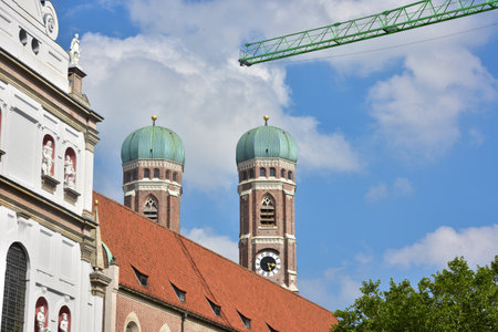 The Frauenkirche in Munich with blue sky and construction crane in the foregroundのeditorial素材