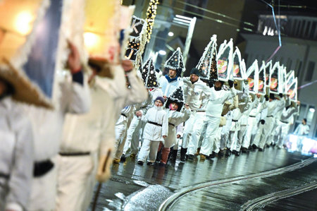 The GlÃ¶cklerlauf is an old custom around Lake Traunsee, men and women wear magnificent caps and bells to drive away the winterのeditorial素材