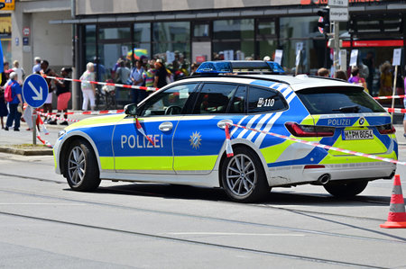 Police car at CSD Pride in Munich. The CSD parade is a political demonstration and colorful parade that takes place every year in Munich. She advocates for equal rights for gays and lesbians.のeditorial素材