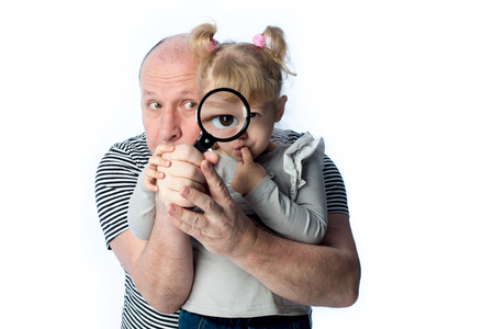 Dad and little girl intently looking at the worldの写真素材