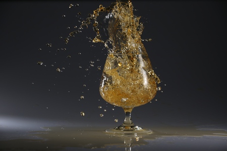 glasses and bottles for brandy and wine in the backgroundの写真素材