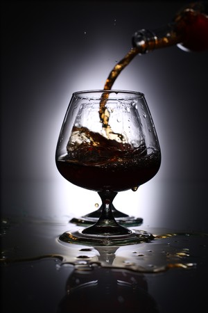 pouring brandy into a glassの写真素材