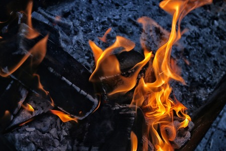 image of burning fire with burnt firewood macro photoの写真素材