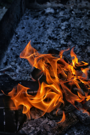 image of burning fire with burnt firewood macro photoの写真素材