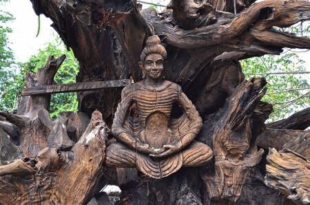 Buddha Wood carving tree in ancient city public places - Stock Photo