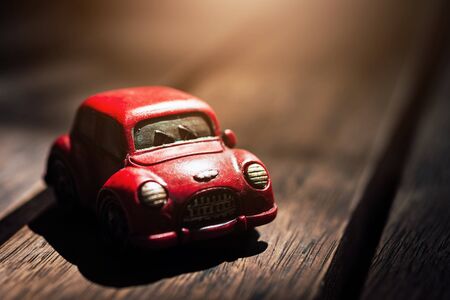 Dark Tone Vintage Red Classic Car on Wood Background with Copy Space for Put Your Text or Made a Wallpaperの写真素材