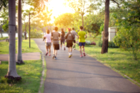 Blurred Picture of Young Men are Running in Outdoor Public Park Background - Lifestyle Sport Recreation Conceptの写真素材