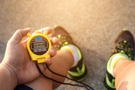 Hand Holding Digital Chronometer for Counting a Time - Sport and Workout Conceptの写真素材