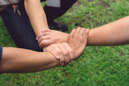 Ring of Hand Meaning to Success Teamwork or Together on Green Grassland Blurred Backgroundの写真素材