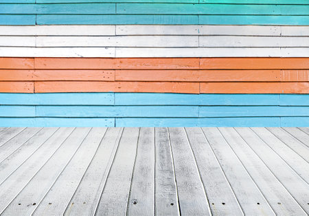 Wooden floor with colorful wall background, wooden planks texture.の写真素材