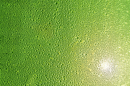 Water drops on green glass texture background. Abstract pattern and texture for design.の写真素材