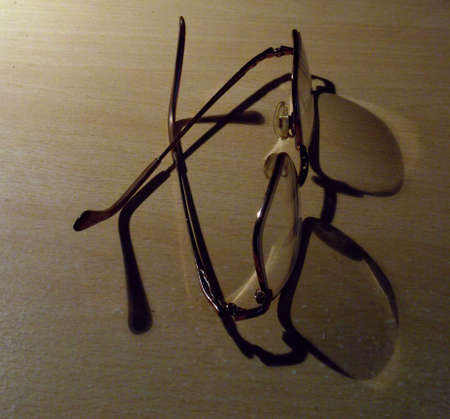 Spectacles on deskの写真素材