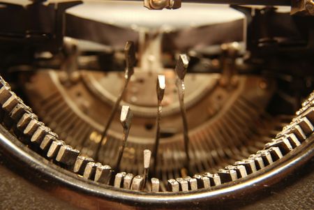 Letters of an old typewriter hitting the paper