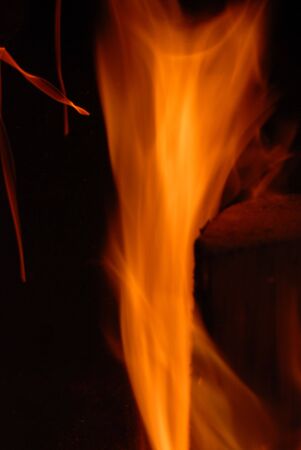 A beautiful flame over burning wood in a fireplace. 