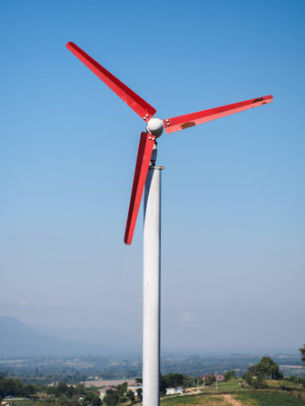 Windmill with town and mountainの写真素材