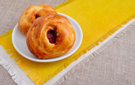 Sweet bun with jam on a yellow napkin.の写真素材