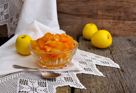 Still life with yellow apples and jam on an old board.の写真素材
