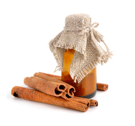 Bark of cinnamon and pharmaceutical bottle. Isolated on whitw background.の写真素材