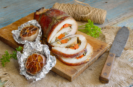 Stuffed Pork Loin Roast with baked garlicの写真素材