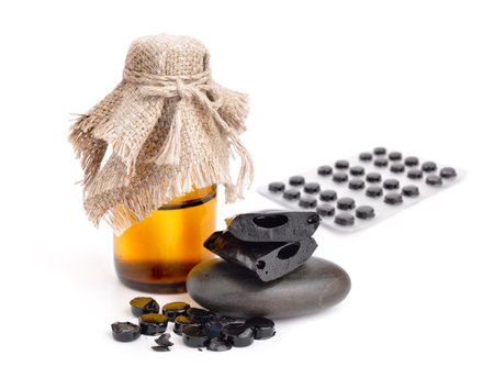 Shilajit, Mumijo. Tablets and solution isolated on white background.の写真素材