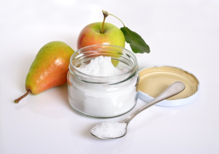 Fructose, or fruit sugar in glass jar. With fruit.の写真素材